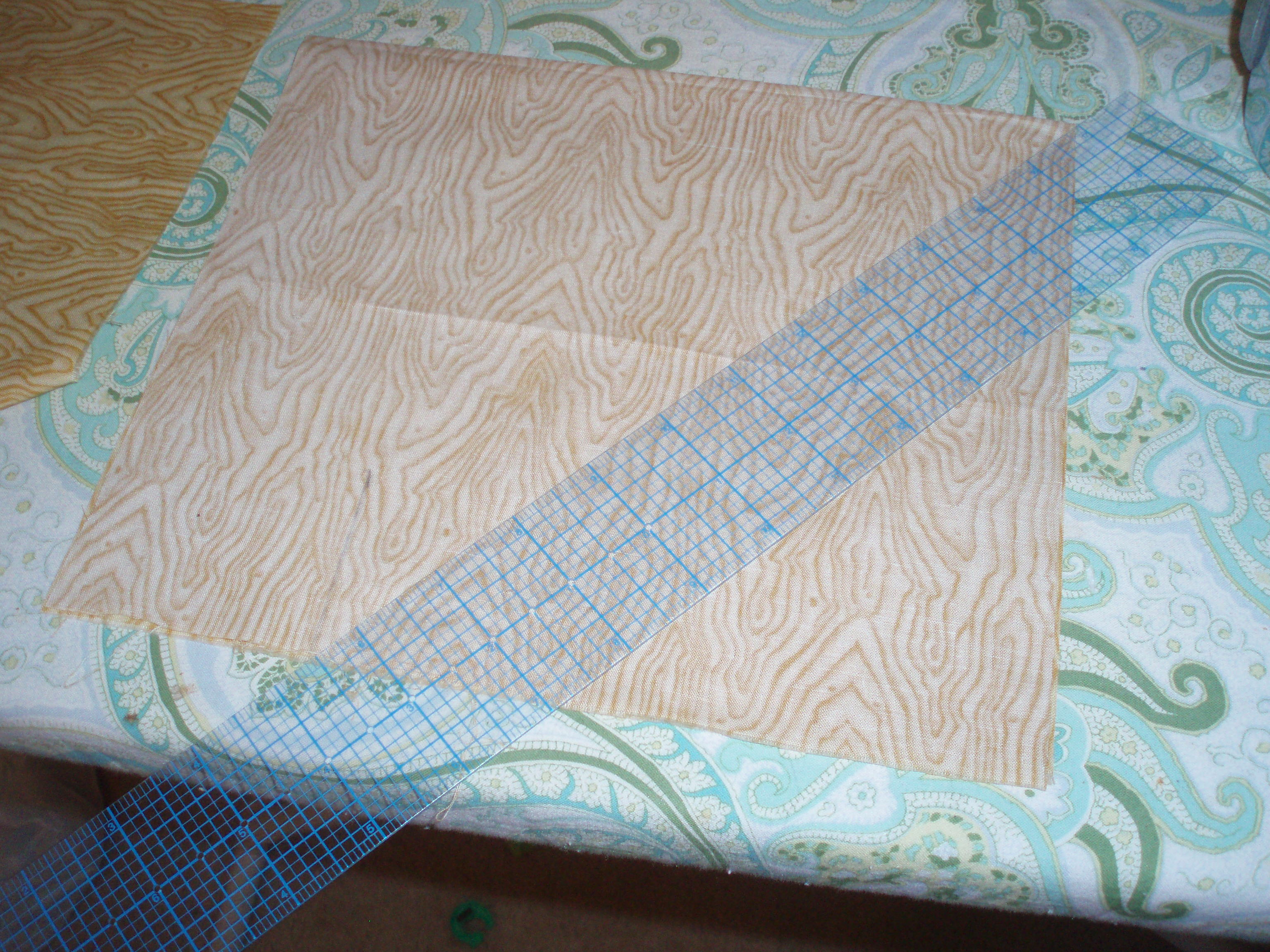 Square of fabric with ruler sitting on top