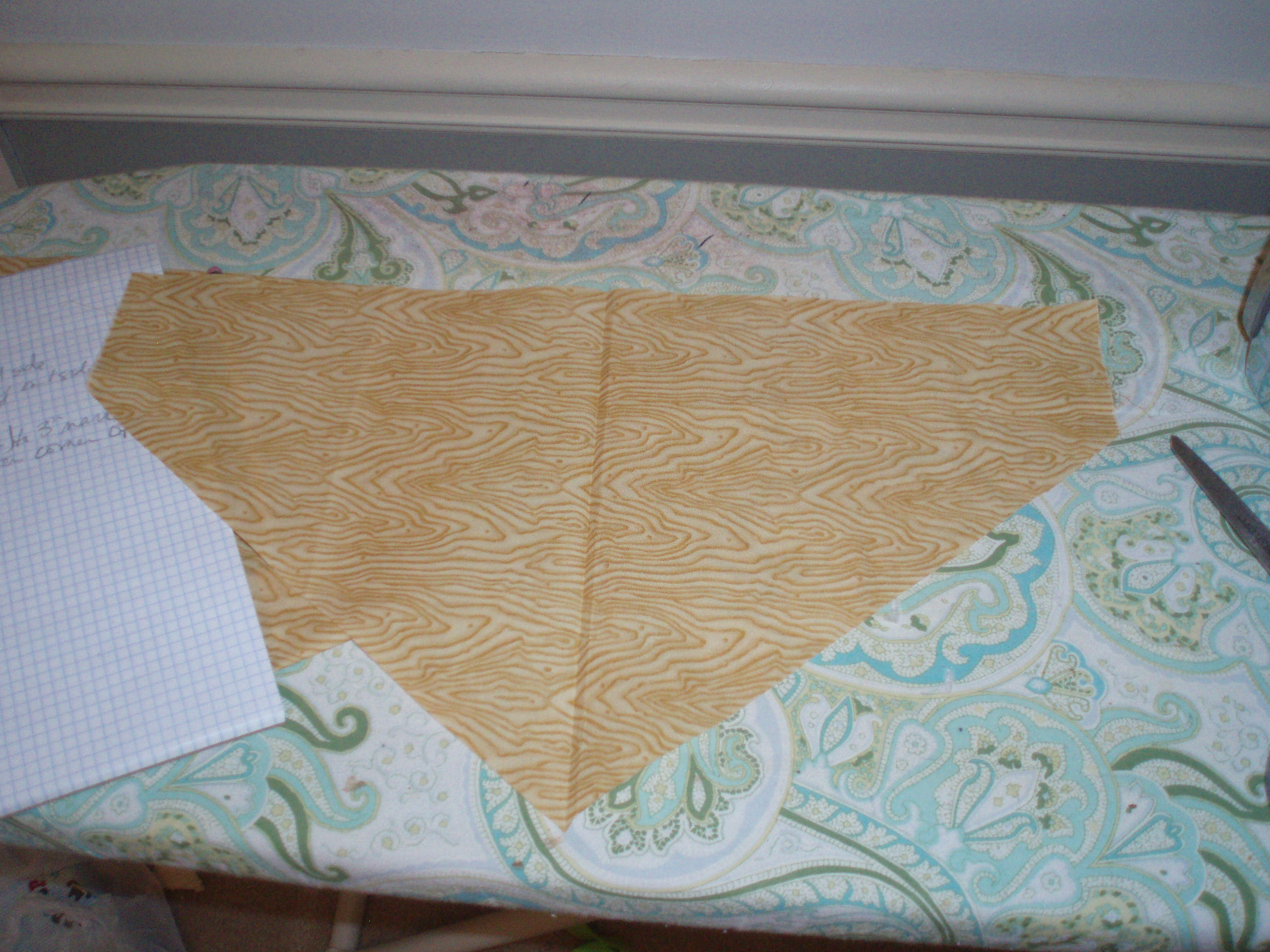Cowboy bib shape of fabric is attained (looks kind of like a home plate in baseball).