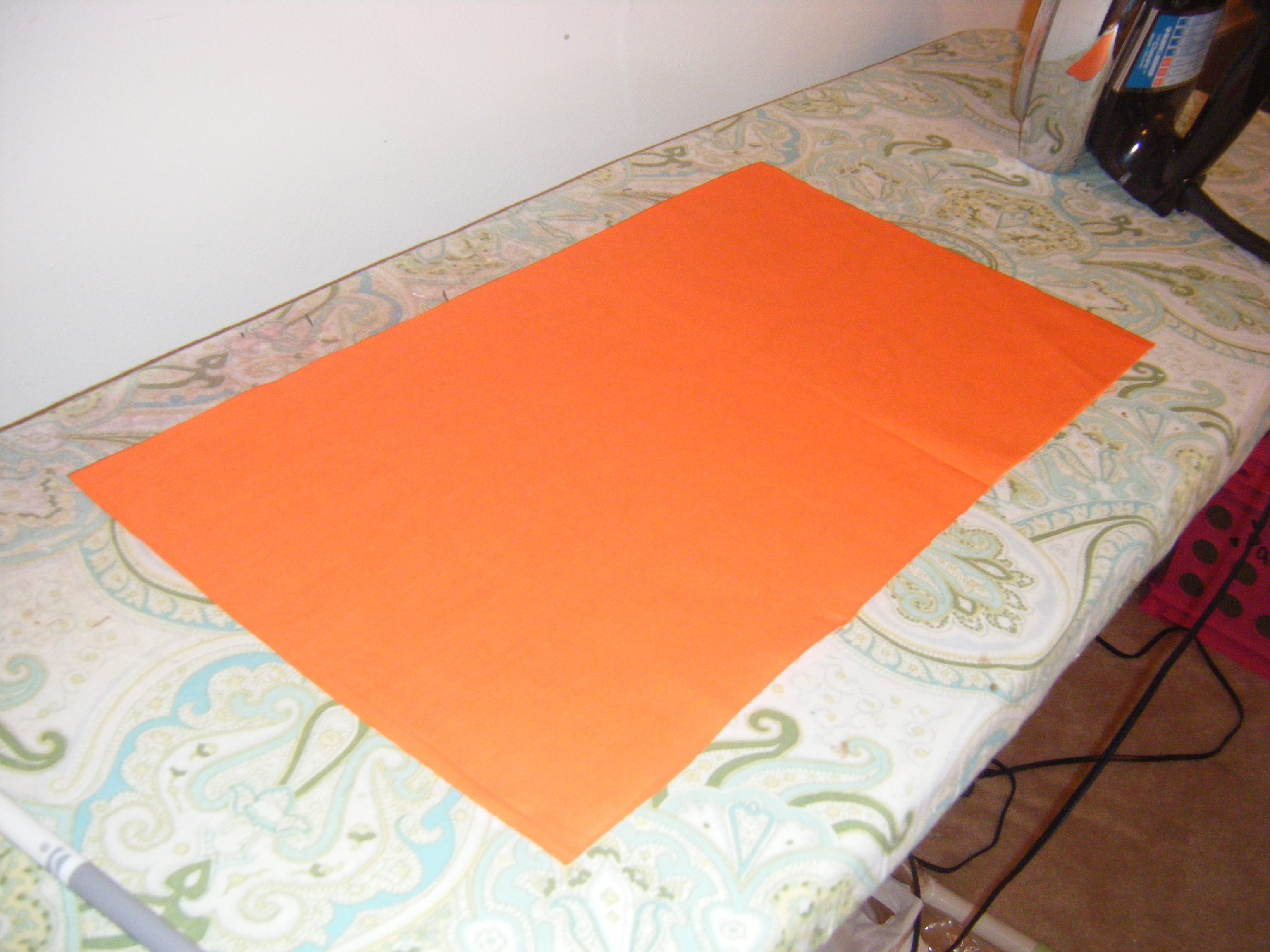 Orange fabric pressed and ready to cut. 
