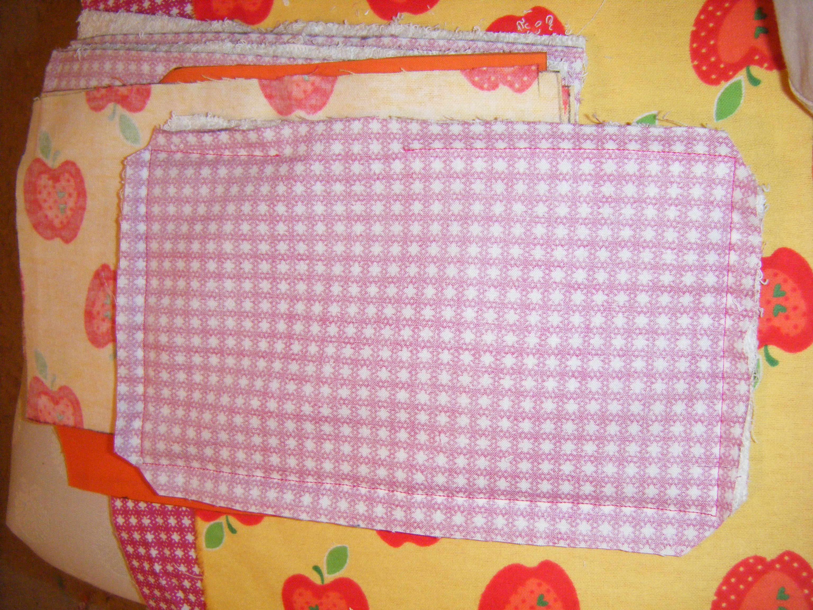 DIY Burp cloth sewn with wrong sides together with a small hole left to flip right side out. Corners are snipped so they'll be sharp when they're turned. 