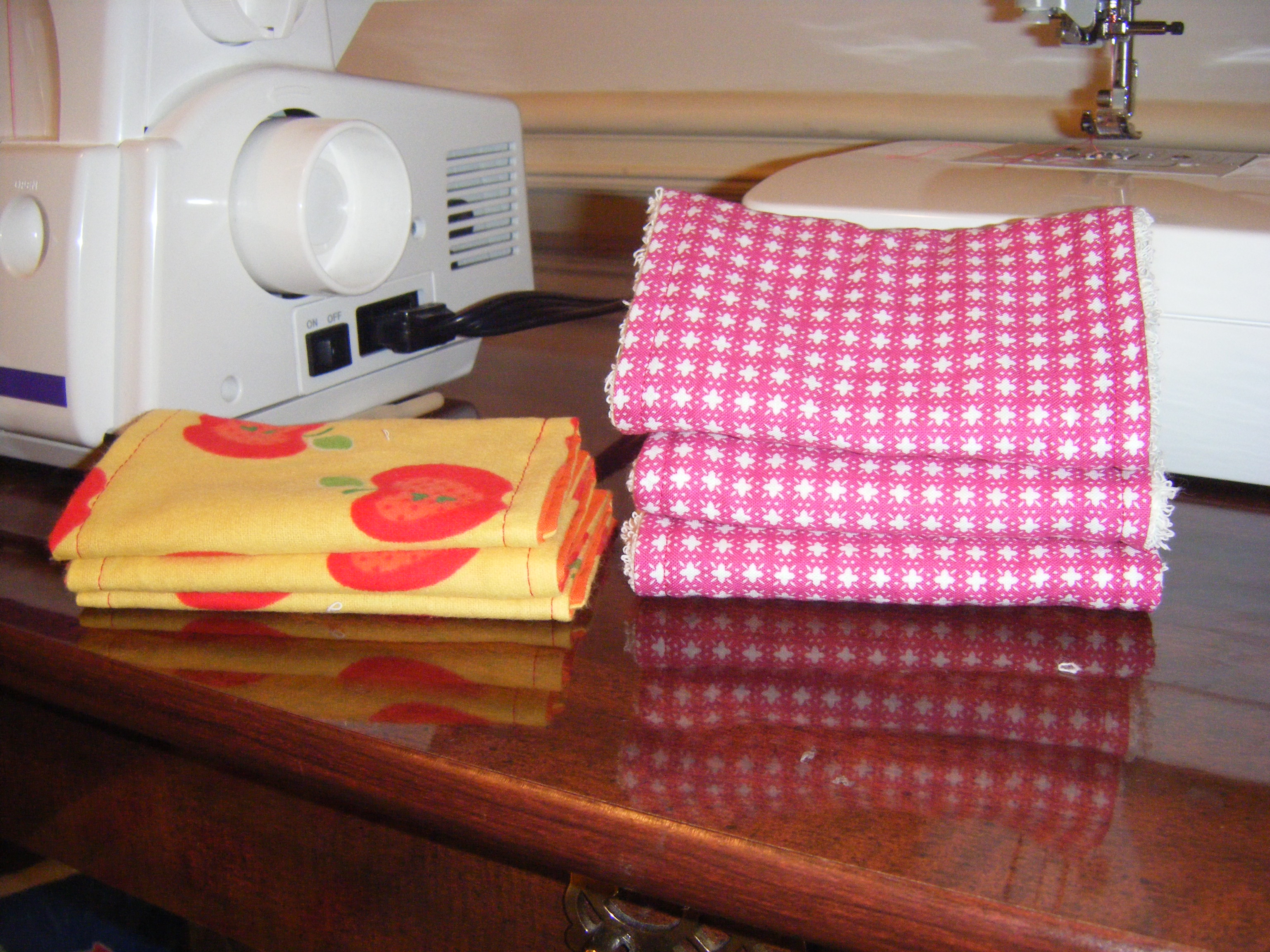 Two stacks of diy burp cloths showing the difference between the thickness of Terry cloth vs. flannel.