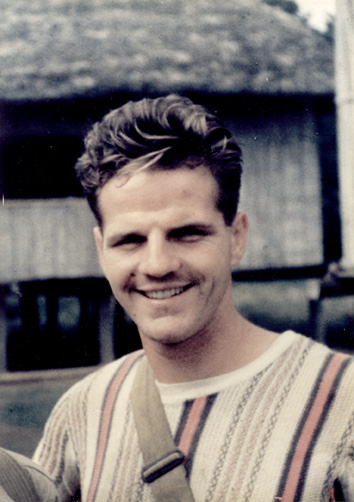 Old photo of jim Elliot in striped sweater with tan bag strap worn cross body